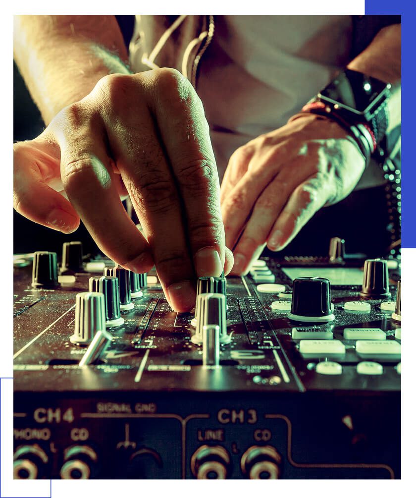 DJ adjusting mixer controls during performance.